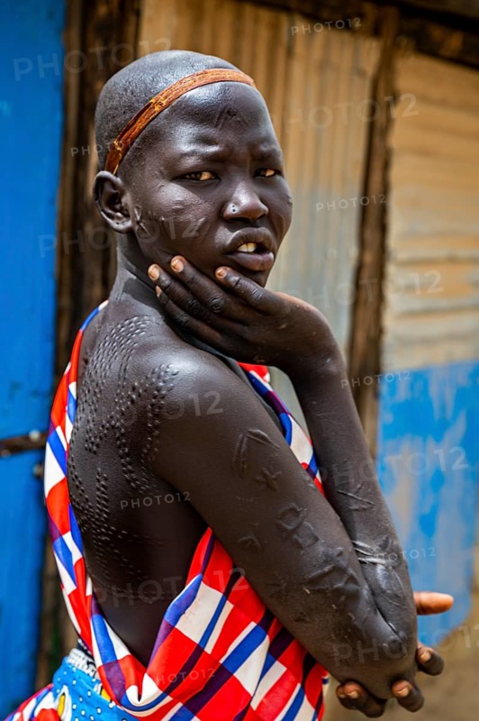 Girl with body scars from the Laarim tribe