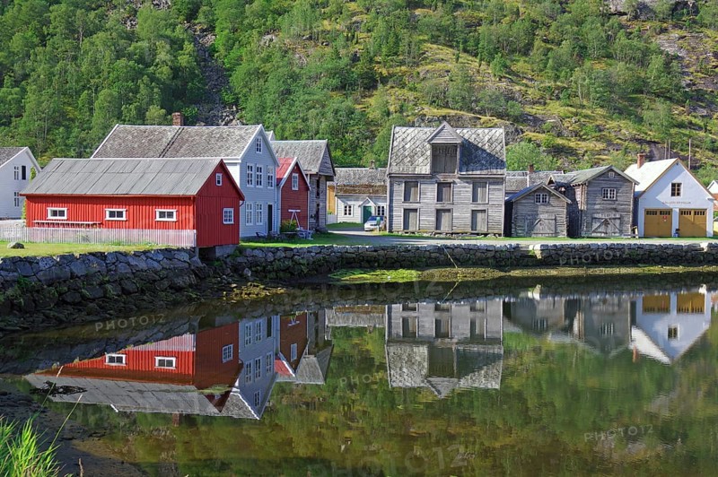 Old wooden houses reflected in the still water