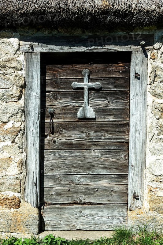 Wooden cross on a door of farm
