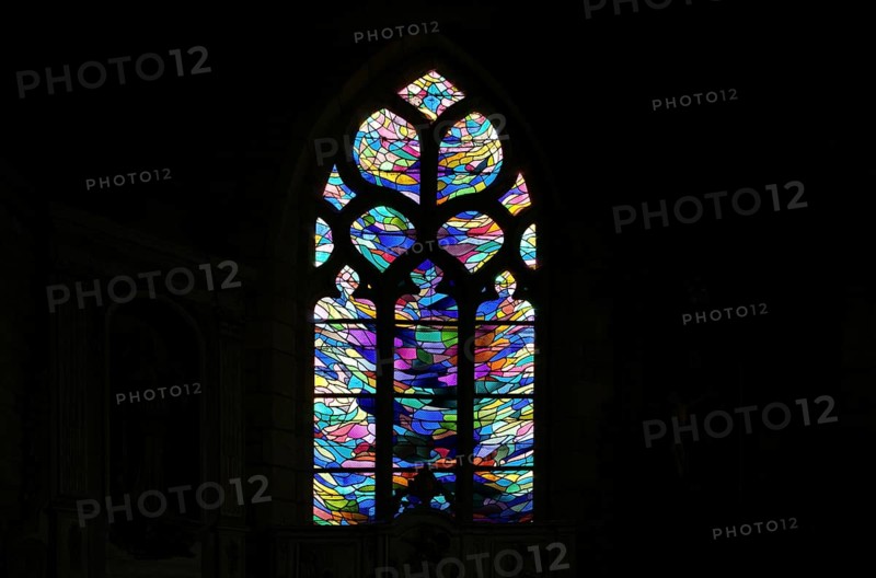 Stained glass window in the chancel of La Chapelle de Notre Dame de Bonne Nouvelle et sa fontaine