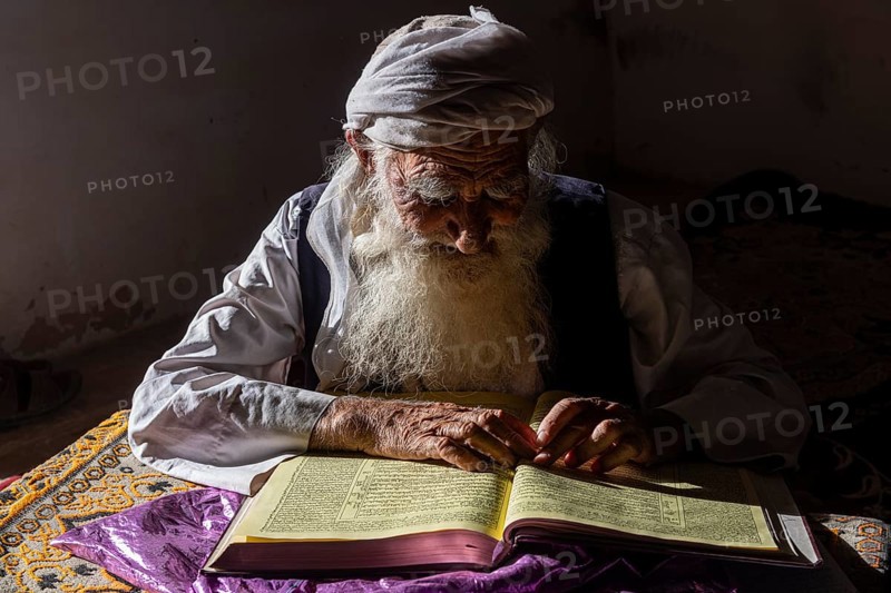Sufi priest studying the holy Quran in the Shrine of Mawlana Abdur Rahman Jami