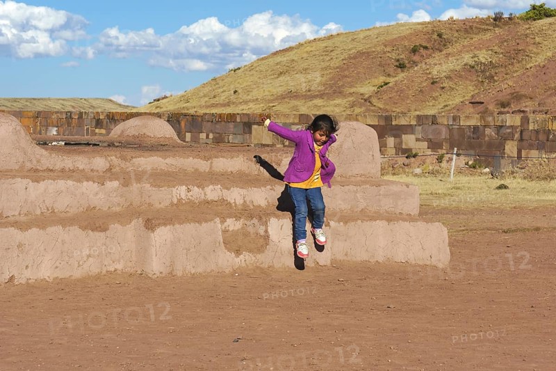 Little indigenous girl jumping from a platform