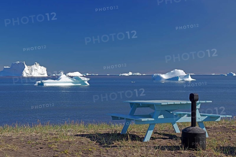 Bench and bay covered with icebergs