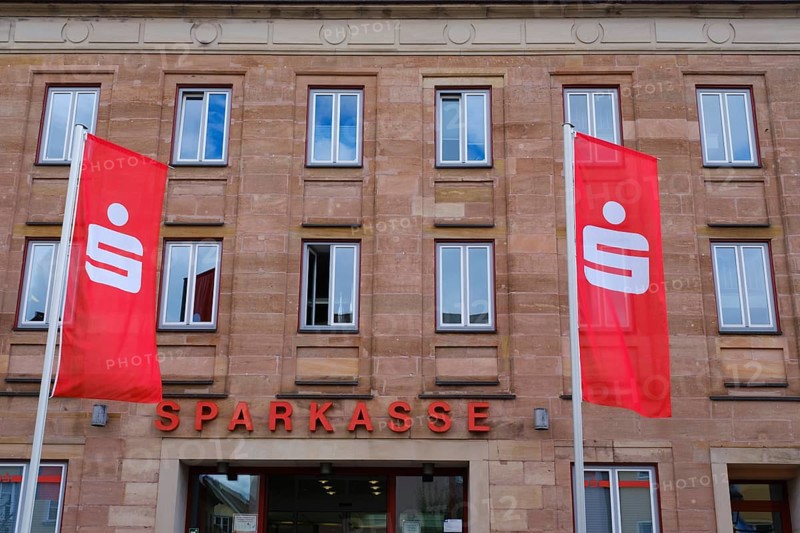Flags in front of the facade of the savings bank