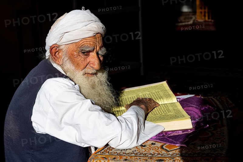 Sufi priest studying the holy Quran in the Shrine of Mawlana Abdur Rahman Jami