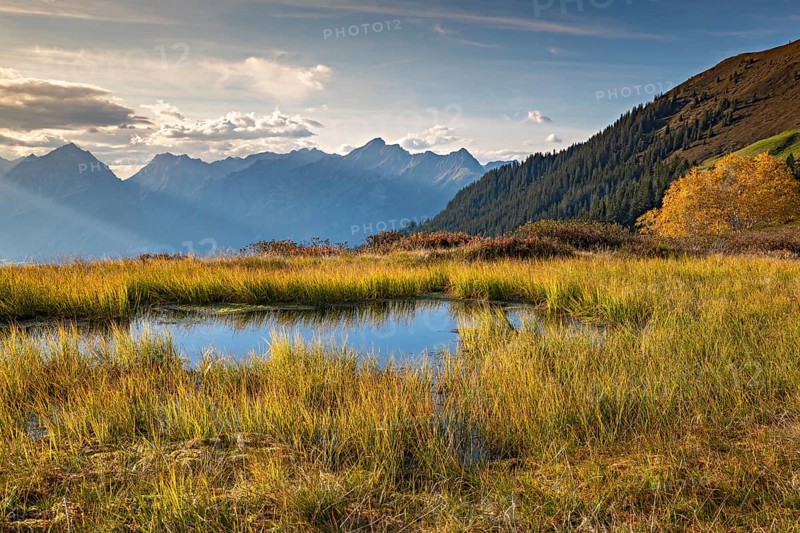 Autumn mountain landscape with small pond