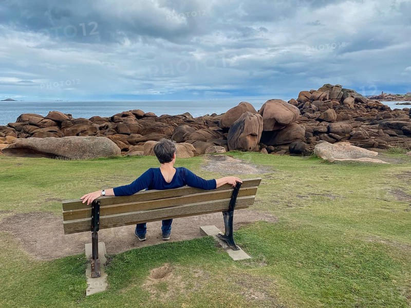 Elderly woman sitting on bench