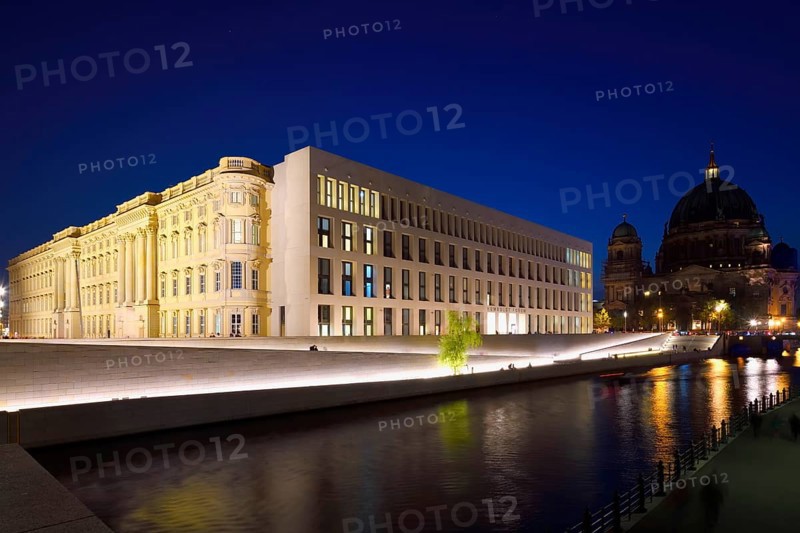 The Berlin Palace or Humboldt Forum along the Spree river and the Berliner Dom illuminated at night