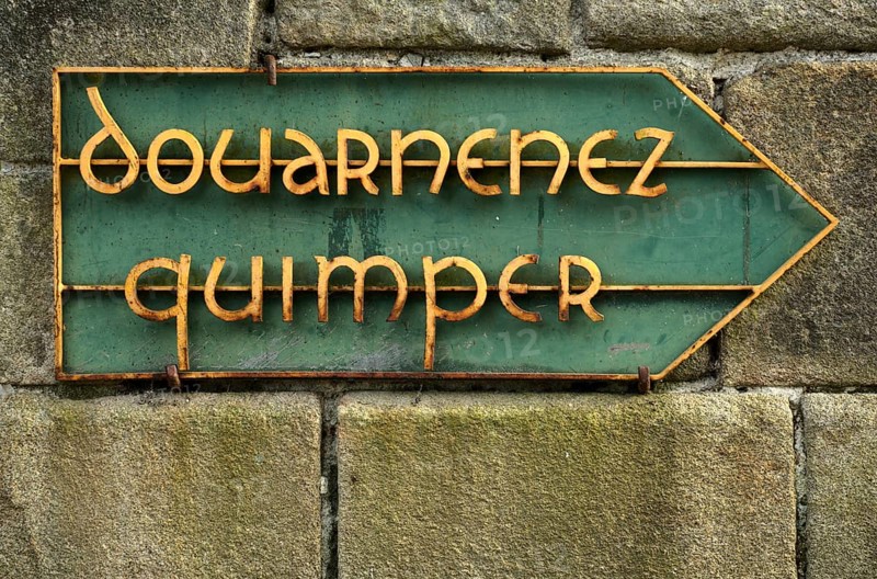 Old road sign shows way to Douarnenez and Qimper