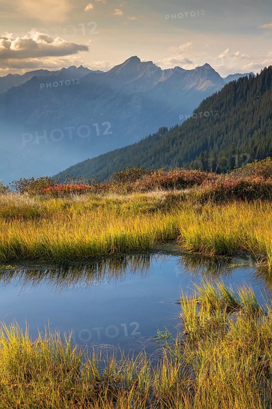 Autumn mountain landscape with small pond