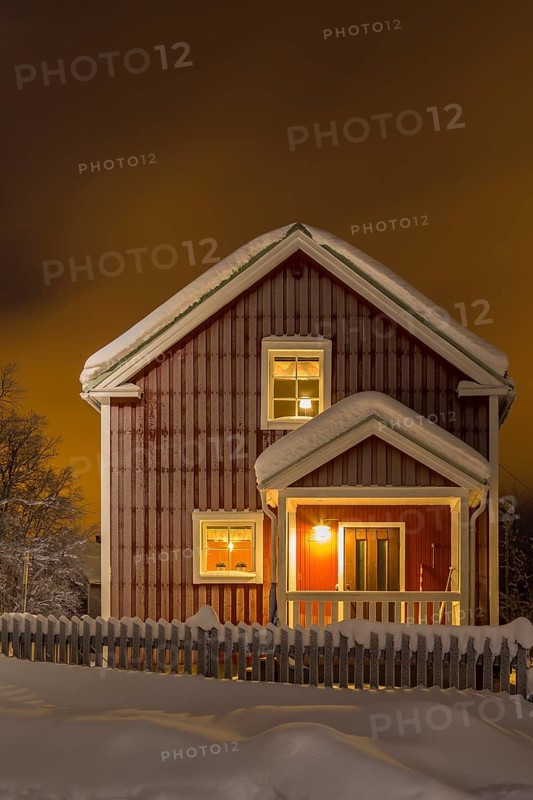 Swedish wooden house in winter at night