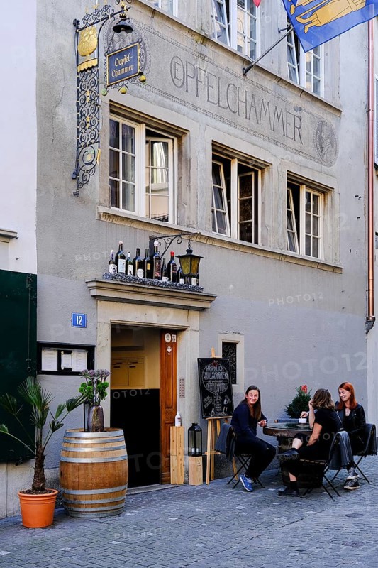 Young people sitting in front of a pub