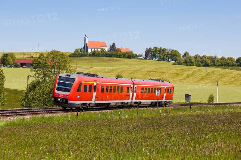 Bombardier Transportation RegioSwinger tilting technology regional train of Deutsche Bahn DB with church St. Alban in Allgaeu Bavaria in Aitrang