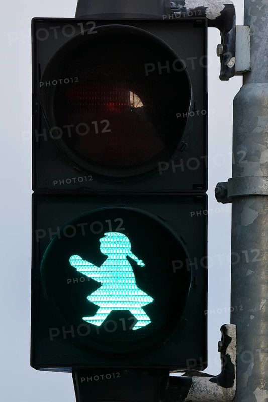 Pedestrian traffic light with green traffic light woman