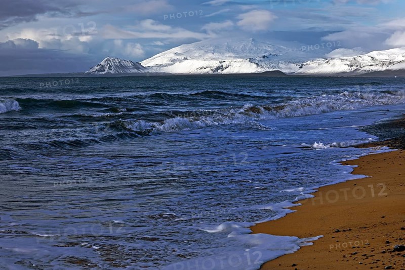 Beach with surf and the volcano and glacier Snaefellsjoekull