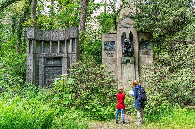 Woman and girl looking at historical gravestones