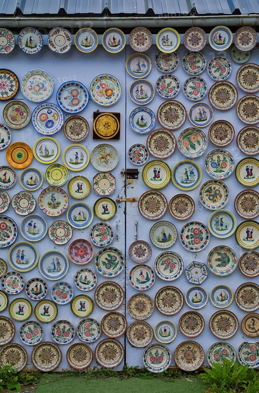 Hand-painted collection plates decorate house wall