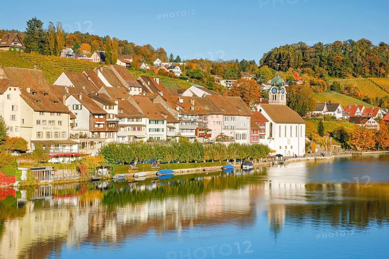 View from the Rhine bridge over the Rhine towards the old town of Eglisau with reflection on the river water