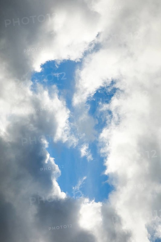 Stratocumulus clouds and blue sky windows form spectacular cloud formation in the sky during Foehn storm