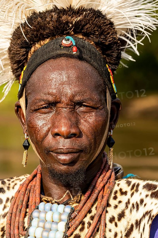 Man from the Toposa tribe posing in his traditional warrior costume