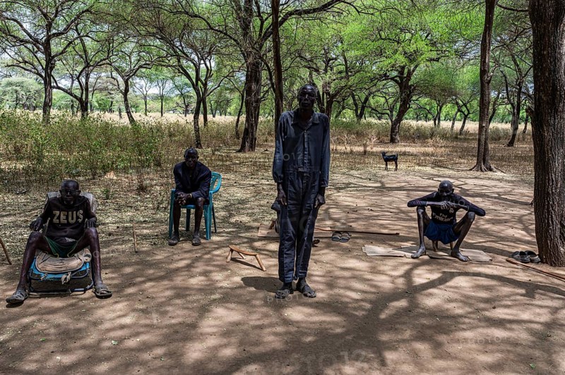 Olders of the Toposa tribe have a reunion under the trees