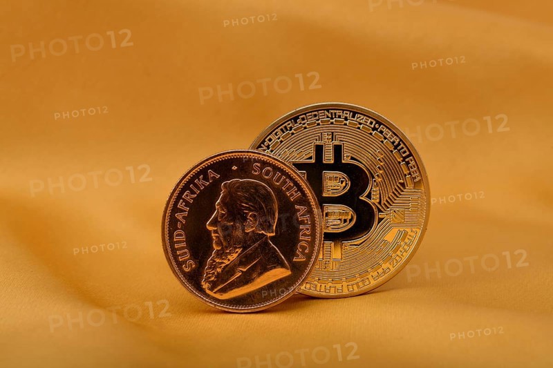Physical gold coin 1 oz gold Krugerrand obverse Paul Kruger and physical bitcoin coin