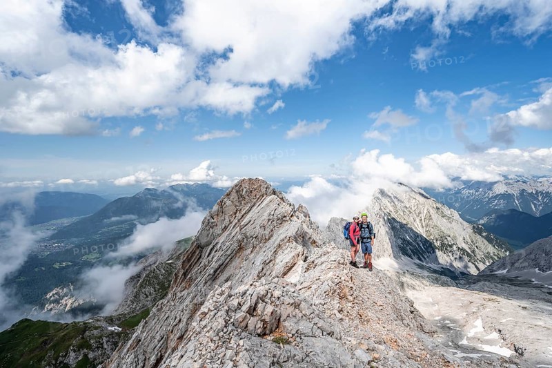 Young couple standing together at the summit after a hike