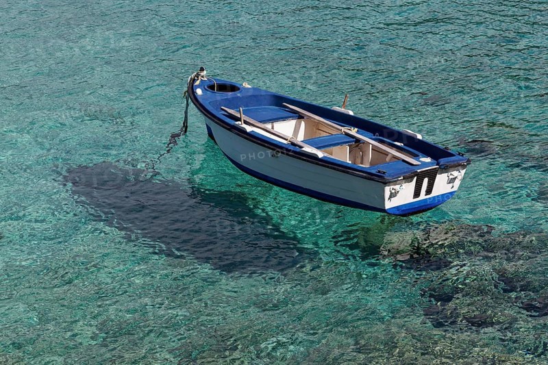 Rowing boat in crystal clear water