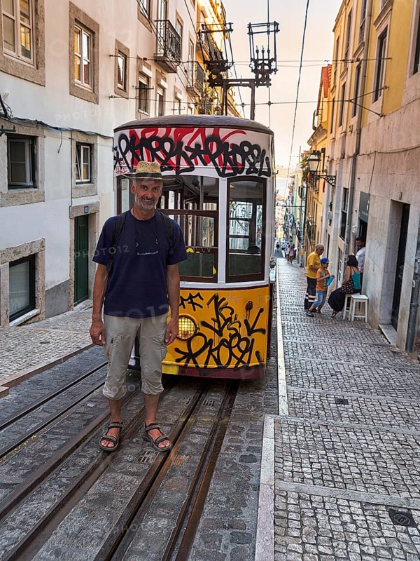Man standing on rails in front of funicular