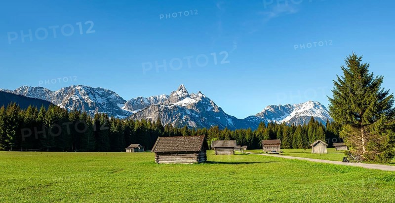 Meadow with hay barns