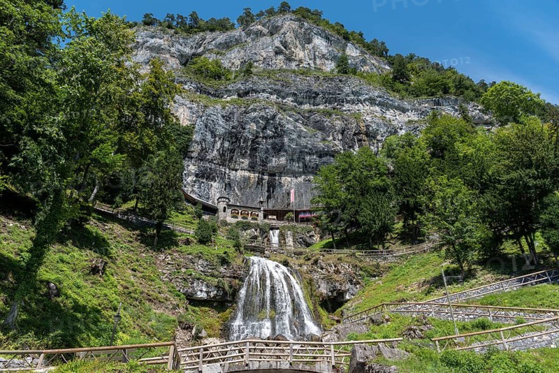 Ensemble of buildings with waterfall in front of the Saint Beatus Caves