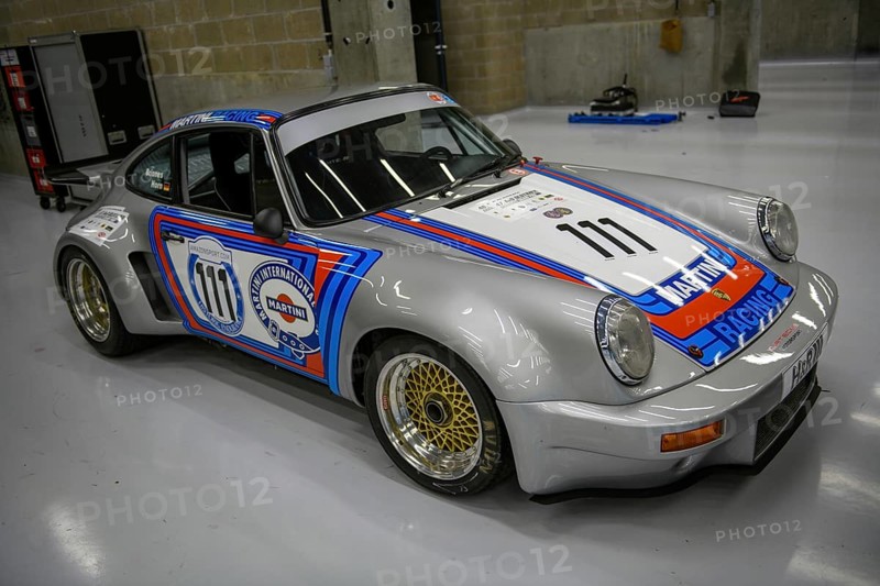 Historic race car Porsche 911 RSR from 1974 in the pits of Circuit de Spa-Francorchamps
