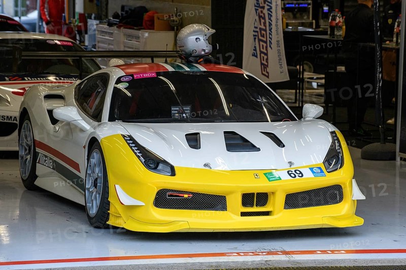 Ferrari 488 Challenge stands in pit box in pit lane