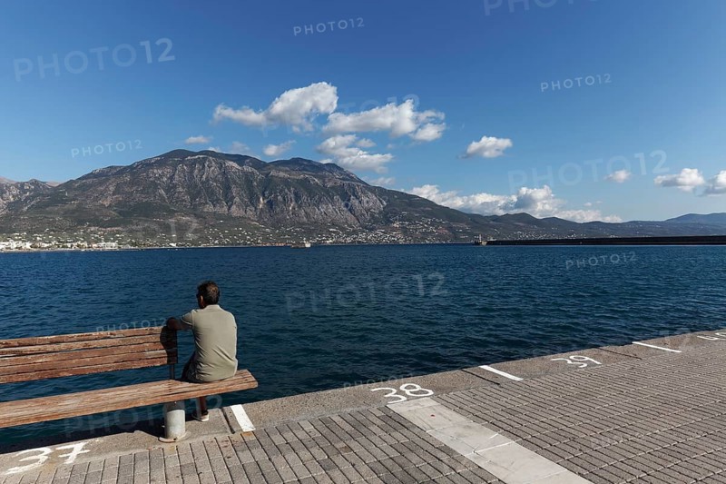Man sitting on a bench at the pier