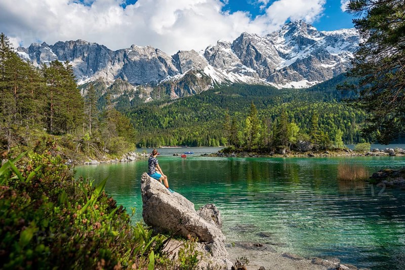 Young man sitting on a rock