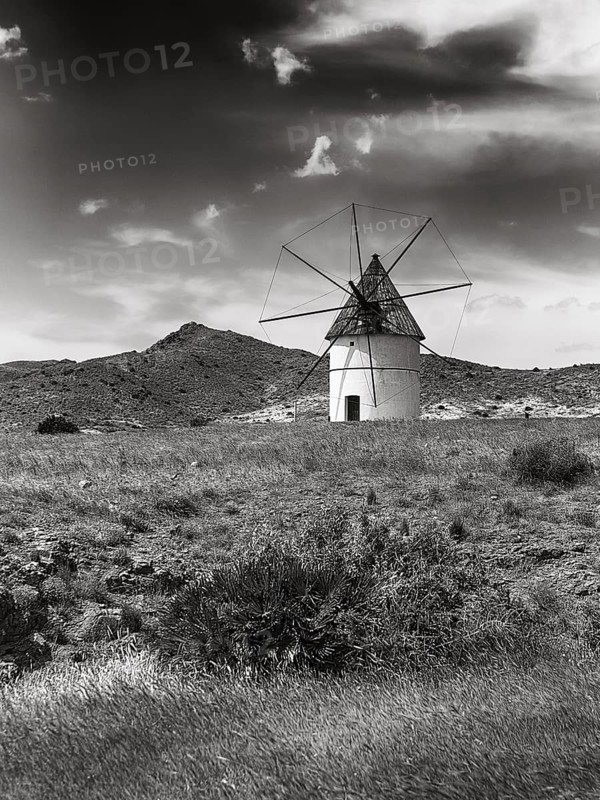 Windmill in barren landscape