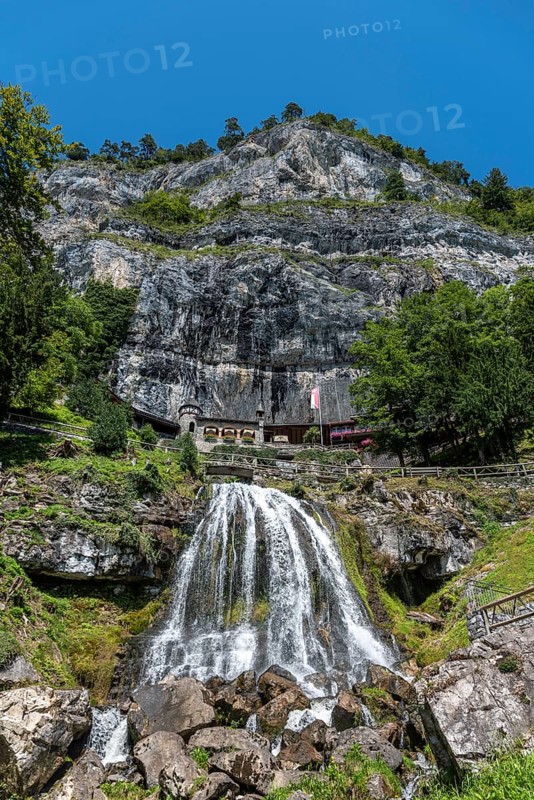 Ensemble of buildings with waterfall in front of the Saint Beatus Caves
