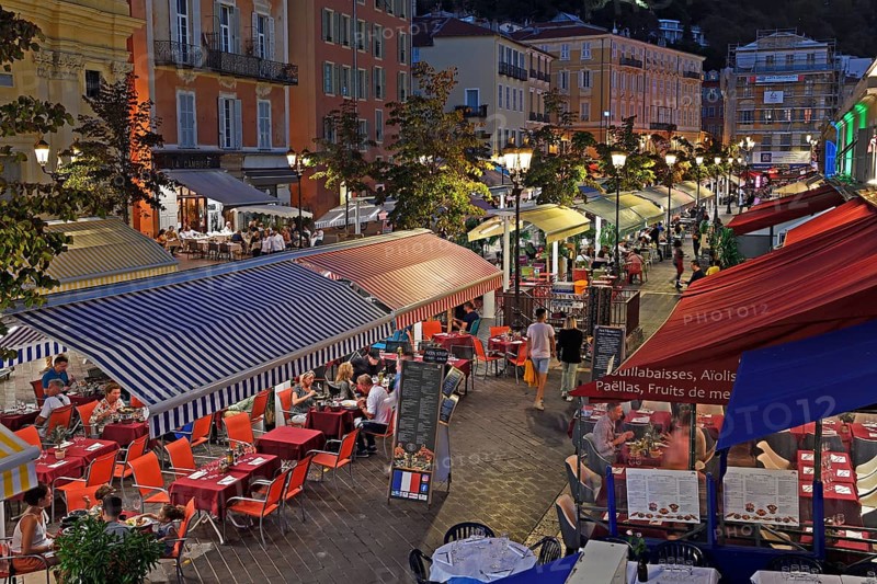 Evening hustle and bustle with restaurants and market stalls on the Cours Saleya
