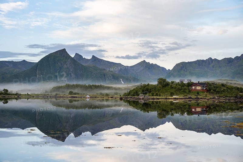 Mountains reflected in fjord near Laukvik