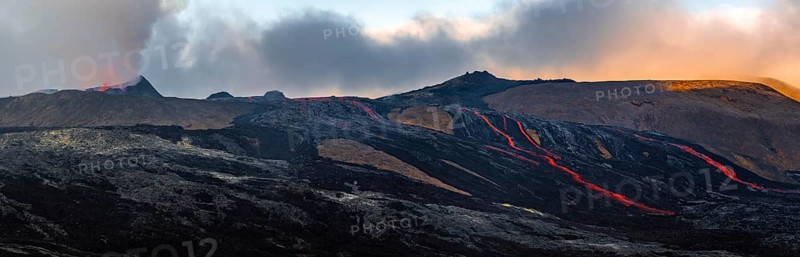 Erupting volcano with lava fountains and lava field