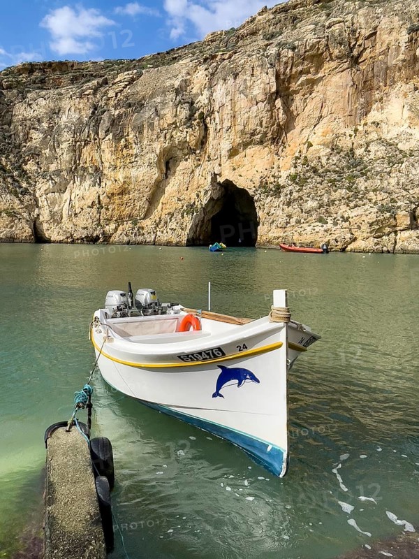 Moored excursion boat without tourists in inland sea of Gozo
