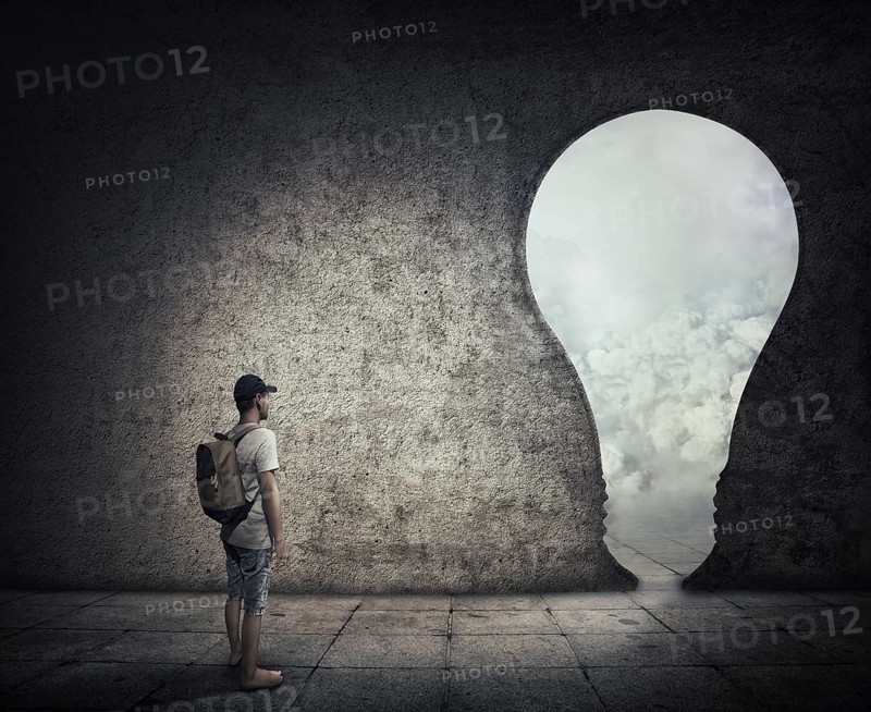 Conceptual image with a person standing in a dark room