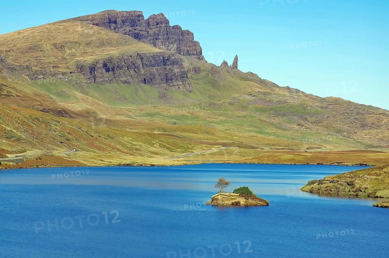 Small island in the loch and prominent rocks and mountains