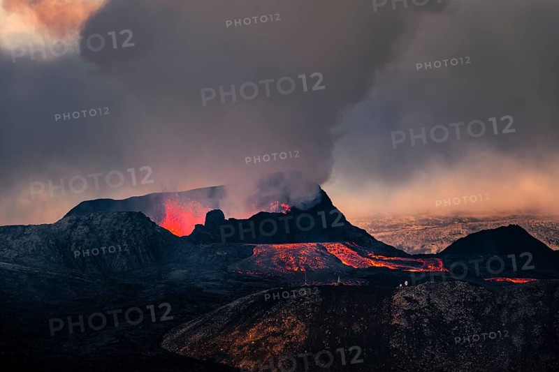 Erupting volcano with lava fountains and lava field
