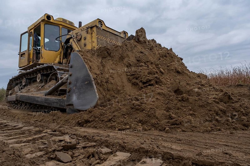 Bulldozer removes dam in the delta Danube river