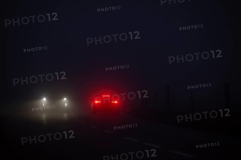 Cars in night and fog oncoming traffic