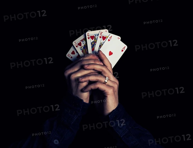 Man hands holding playing cards with the strongest combination