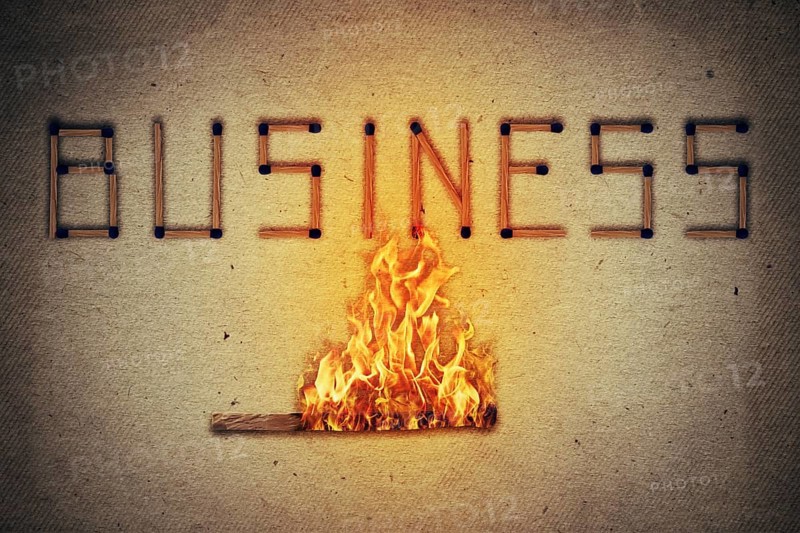 Burning match setting fire to its neighbors in arranged in shape of business word