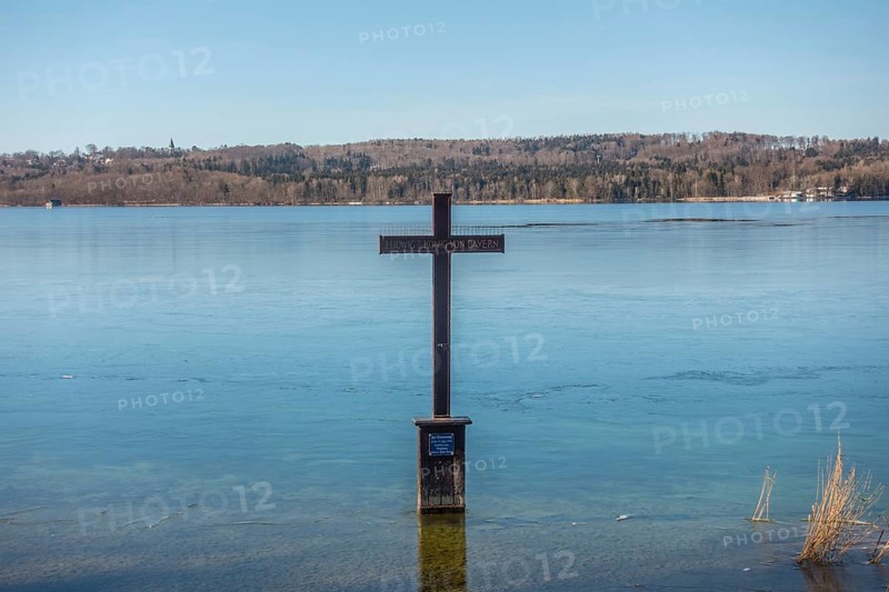 Winter memorial cross in the icy water at the spot in the shallow shore area of Lake Starnberg where King Ludwig II of Bavaria was found dead in 1886