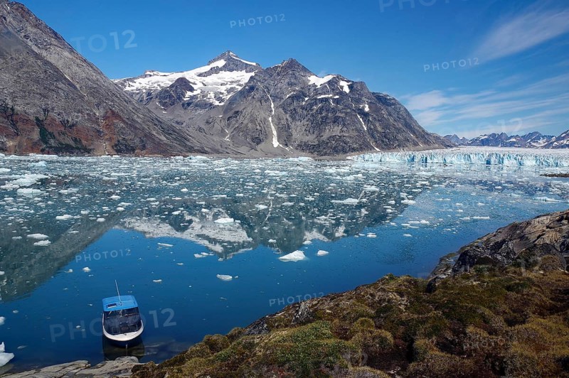 Small boat in the calm waters of a fjord